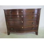 A serpentine fronted, inlaid mahogany chest of four drawers.