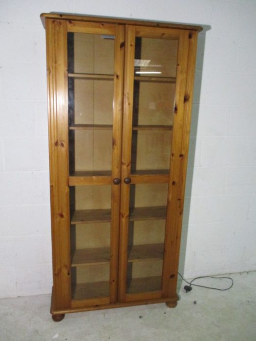 A two door pine display cabinet