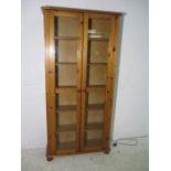 A two door pine display cabinet