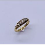 An 18ct gold "boat" ring set with 5 diamonds