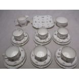 A Shelley "Charm" part tea set comprising of a sugar bowl, creamer jug, six trios and a sandwich