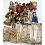A collection of various vintage dolls and doll making supplies