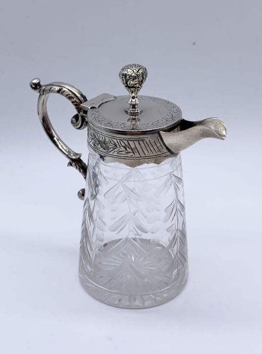 A silver plated and cut glass whiskey tot/oil jug