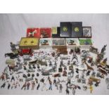 A collection of lead figurines including soldiers, weapons, animals, barrels, horses etc - some