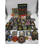 A collection of embroidered blazer emblems and crests etc.