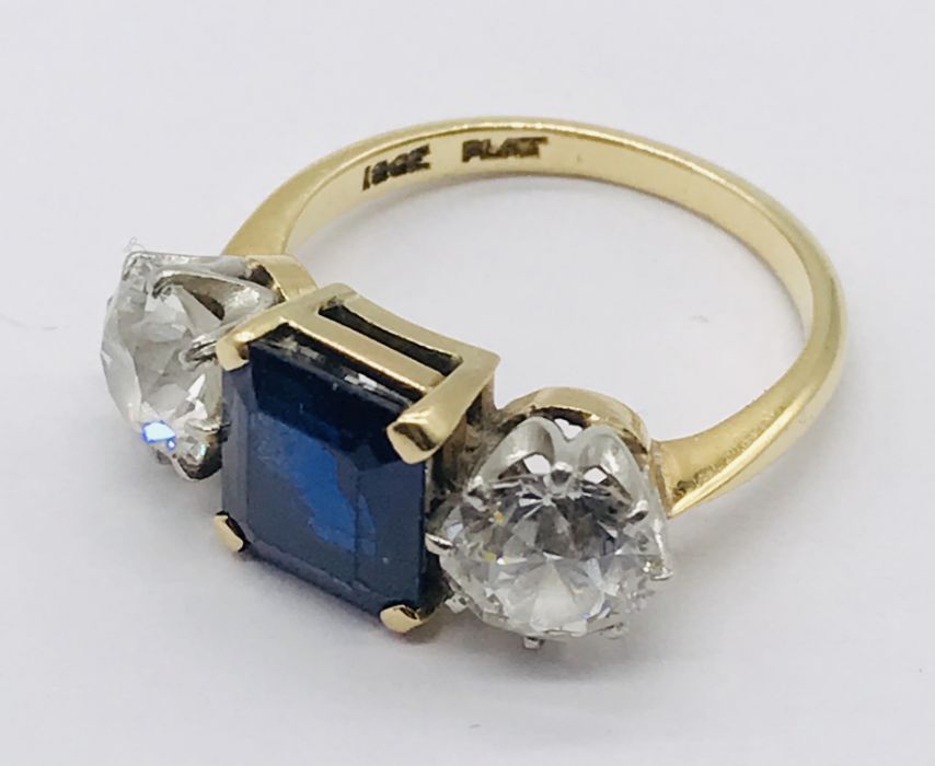 A diamond and sapphire three stone ring. The diamonds measuring 1ct each (6.5mm diameter x 3.75mm - Image 3 of 7