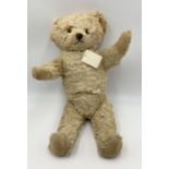 A 1930's Knickerbocker blonde plush covered teddy bear with cast metallic nose, amber eyes,