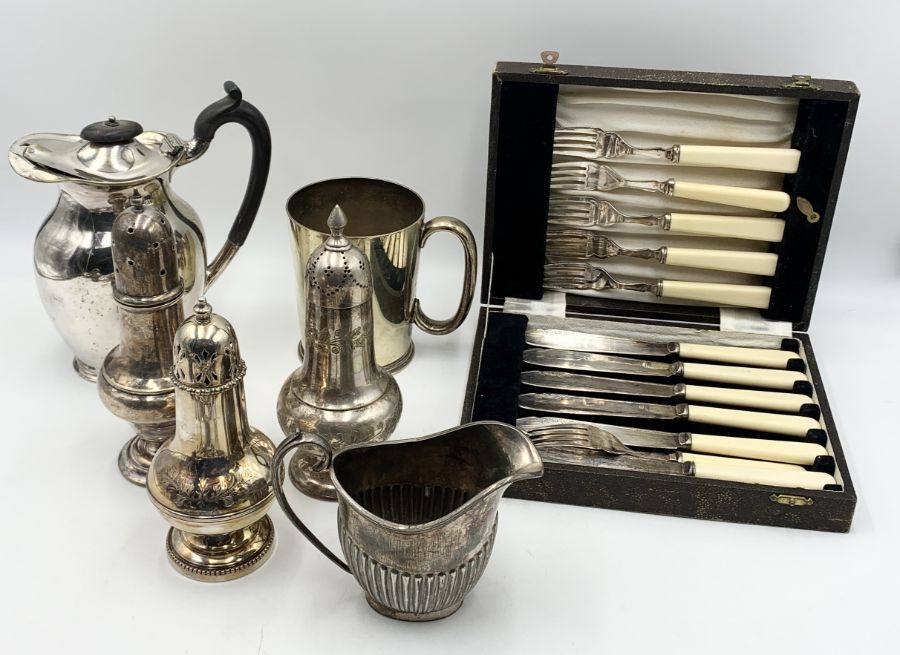 A collection of mainly silver plated items including a jug by Watherston - Pall Mall East awarded at