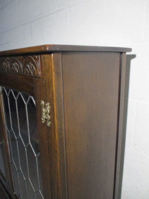 An oak display cabinet with linen fold decoration and cupboard under - Image 6 of 13