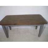 A rustic pine farmhouse table with grey painted base and single drawer