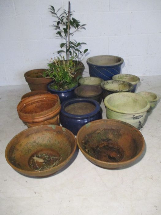 A collection of garden pots including glazed and terracotta.