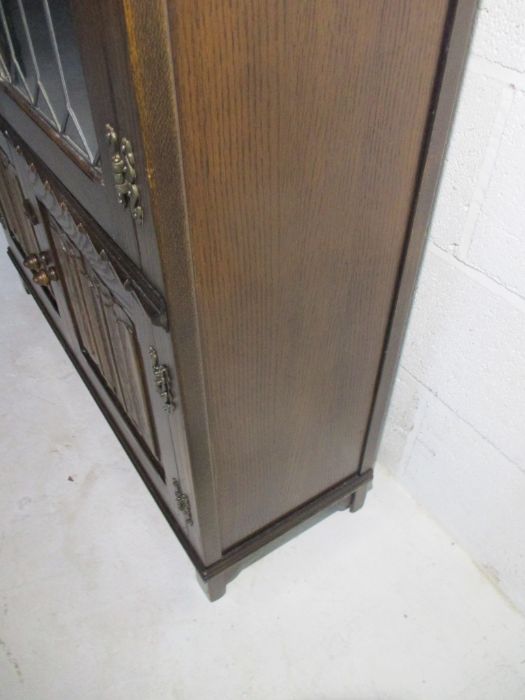 An oak display cabinet with linen fold decoration and cupboard under - Image 7 of 13