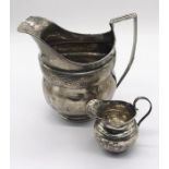 Two hallmarked silver jugs ( larger one A/F), total weigh 134.8g