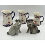 A pair of pottery Pugs along with a graduated set of three jugs