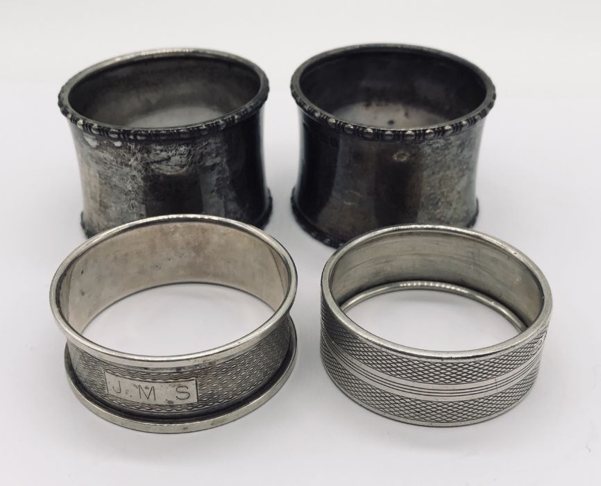 Four hallmarked silver napkin rings along with four continental silver spoons - Image 2 of 3