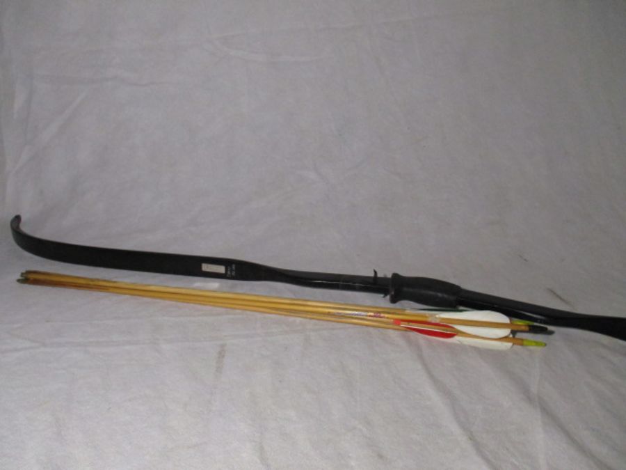 A composite archery bow with four arrows