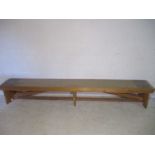 An industrial wooden bench from the Axminster Carpets factory - length 299cm, width 38cm, height