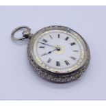 A continental 935 silver fob watch with enamelled dial with gilded decoration, inscription to