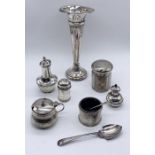 A collection of hallmarked silver items including a trumpet vase (A/F) various condiments