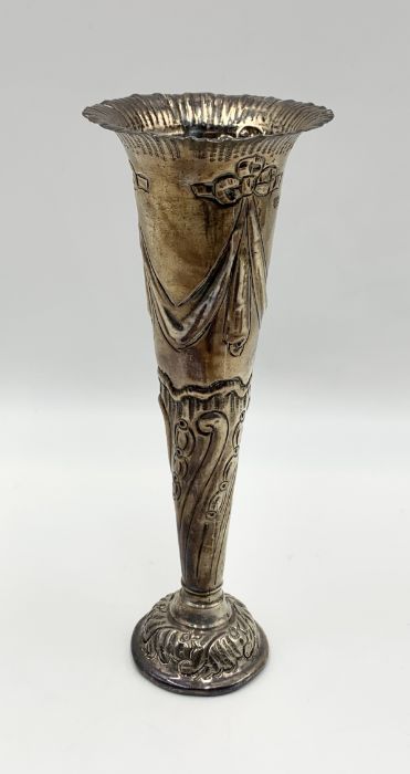 A weighted hallmarked silver trumpet vase with repousse decoration