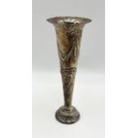 A weighted hallmarked silver trumpet vase with repousse decoration