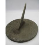 A circular slate sundial with Roman numerals, diameter 24.5cm