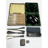 A collection of silver handled items including glove stretchers, shoe horns, hallmarked silver stamp