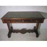 A Victorian centre/writing table with three drawers and leather inset top