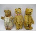 A collection of three plush jointed vintage teddy bears with glass eyes and stitched noses