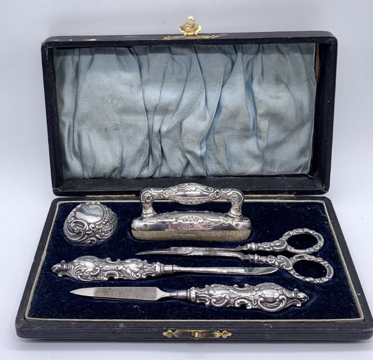A hallmarked silver manicure set- box in need of attention