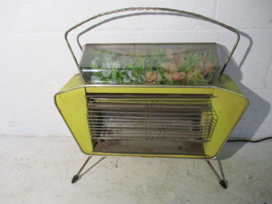 A 1950's kitsch electric fire with plastic flower display to top- please note this is for decorative