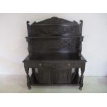 A heavily carved, turn of the century oak sideboard with ornately carved bird supports