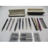 A collection of vintage pens, including Parker.