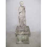 A composite stone statue of a lady on a large plinth, stamped Papini.A