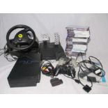 A Playstation 2 console with two controllers, cables and manual, along with a selection PS2 games,