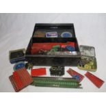 A collection of vintage Meccano in a black storage tin