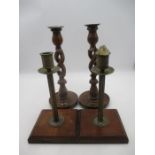 Two pairs of candle sticks one wooden barley twist, one brass.