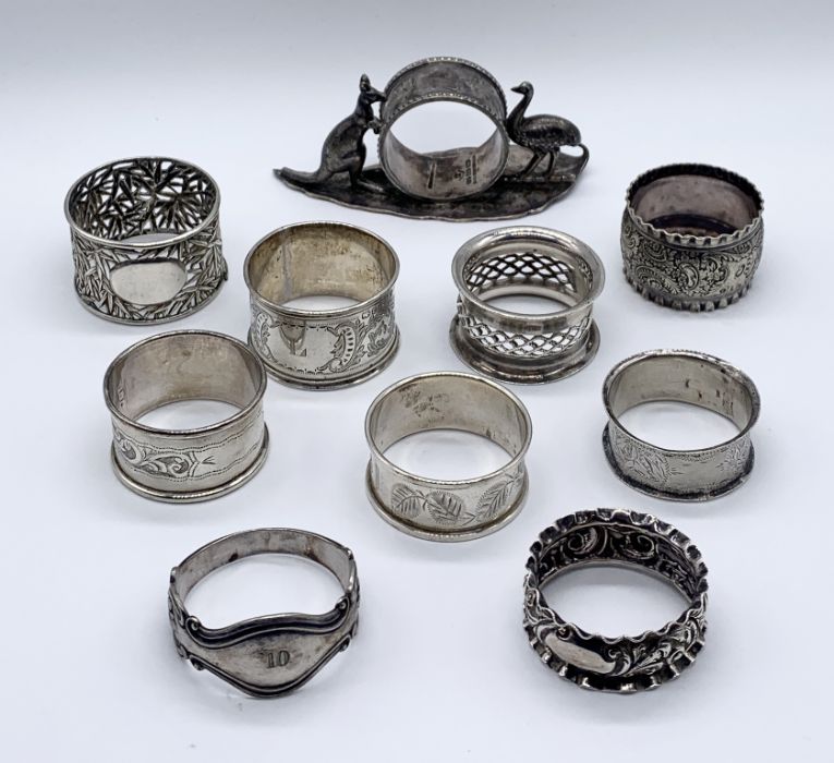 A collection of 7 hallmarked silver napkin rings along with an Australian silver plated version