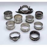 A collection of 7 hallmarked silver napkin rings along with an Australian silver plated version