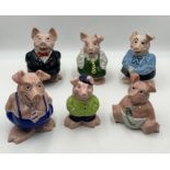 A collection of six Wade Natwest piggy banks