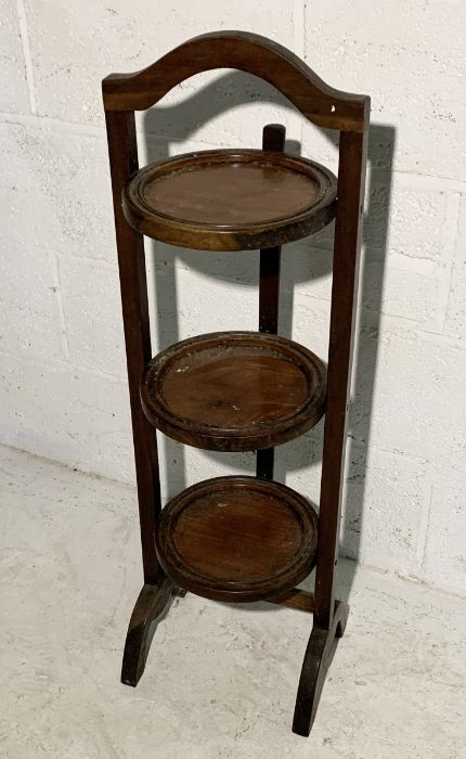 A vintage folding three-tier cake stand