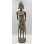 A carved African wooden fertility statue, height 64cm