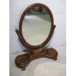 A Victorian mirror with two lidded storage compartments.