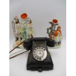 A vintage bakelite telephone along with two Staffordshire flatbacks