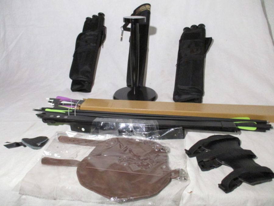 A collection of archery accessories including recurve bow ( no fixings) arrows, quivers etc.