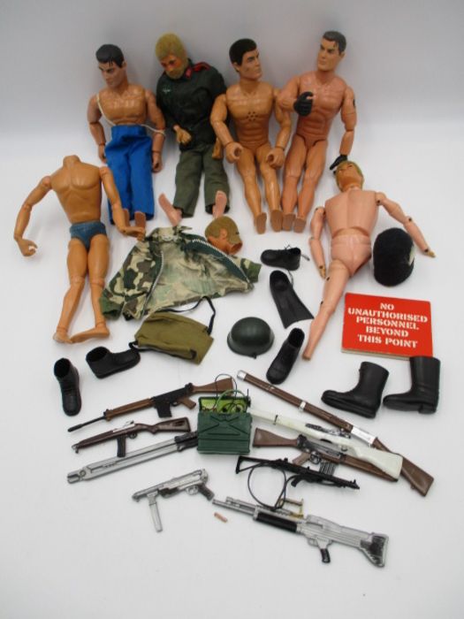 A collection of vintage Action Man figures with various accessories including clothing, weapons,
