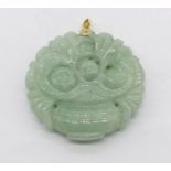 A carved jade pendant with 14ct gold mount