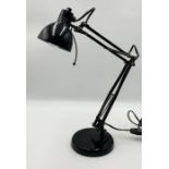 A black anglepoise desk lamp