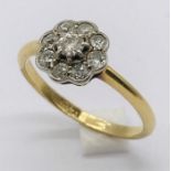 An 18ct gold cluster ring, with central white sapphire and surrounding diamonds