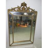A large cushion style mirror with sectional plate border, 145cm height, 90cm wide